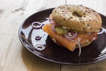 Whole Grain Bagel with salmon, cream cheese, onions and kosher pickle