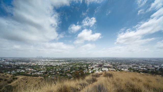 Beautiful clouds moving over city of Los Angeles cityscape. 4K UHD Timelapse.