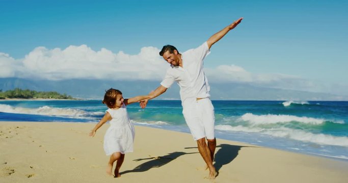 Father and daughter playing having fun at the beach