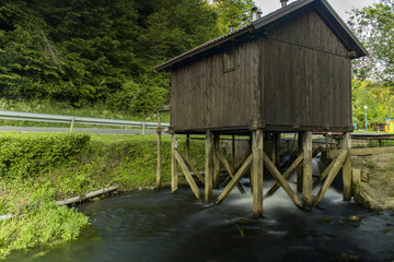 old wooden water mill on the river
