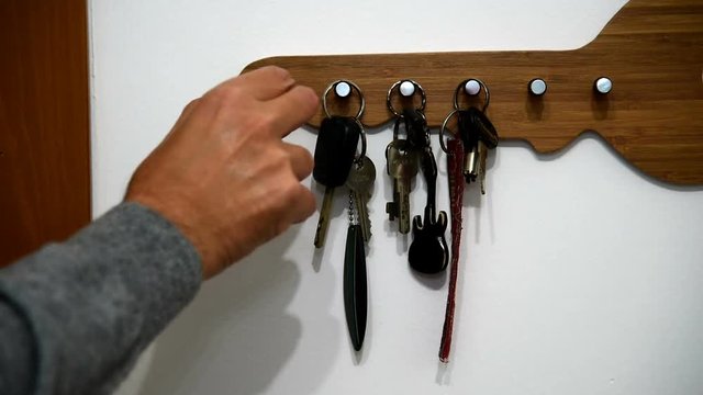 Man grabs house key from the key holder