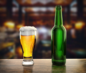 bottle is glass of fresh beer on the table of a brewery