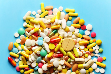 Colorful pills on a blue background