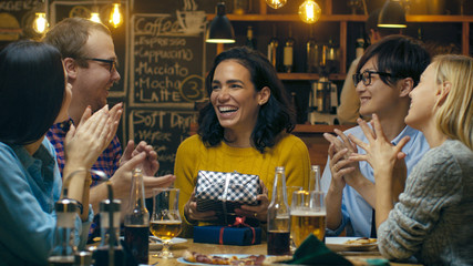 In the Bar/ Restaurant Best Friends Give Presents to a Beautiful Hispanic Woman, Wishing Her Happy Birthday. Everybody is Happy.