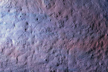 old rough surface of a concrete wall with an uneven coating