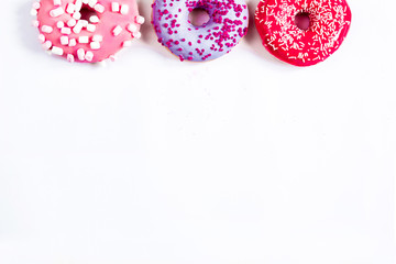 three round donut red purple pink on top of white background