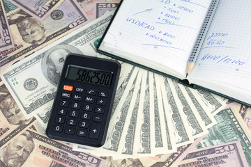 calculator green notebook with dollar bills on the background of money borrowed money concept