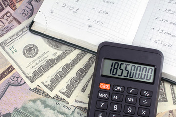 calculator green notebook with dollar bills on the background of money borrowed money concept