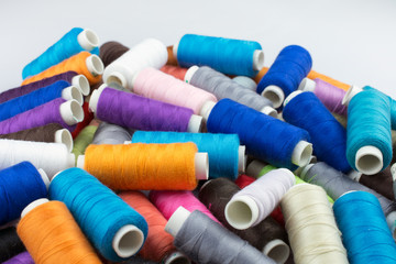 multicolored thread on reels selective focus