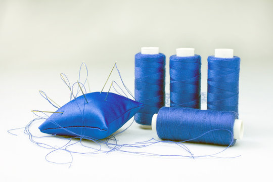 blue threads on reels pincushion for needles