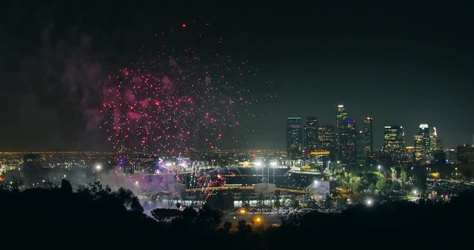 Fireworks display over city of Los Angeles downtown skyline at night. 4K UHD.