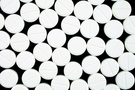 white round tablets painkiller copy space, black background, selective focus © SecondSide