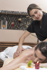 Obraz na płótnie Canvas Spa woman. Female enjoying relaxing back massage in cosmetology spa centre. Body care, skin care, wellness, wellbeing, beauty treatment concept.