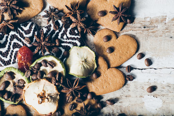 abstract creative background toned heart cookie with slices of dried apples with star anise coffee beans and chocolate on wooden background