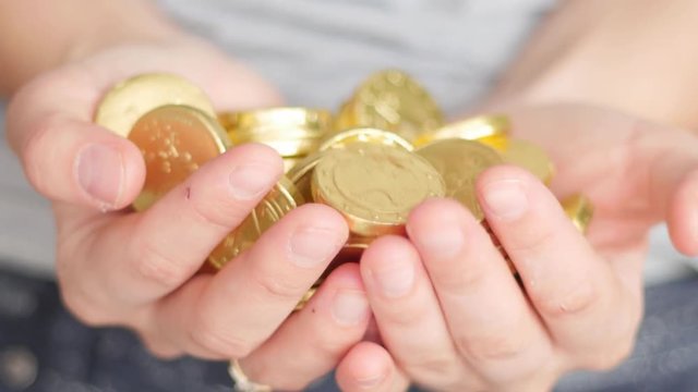 golden coins in hands