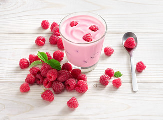 Yogurt with raspberry on white wooden table. Fresh yogurt. Healthy food concept. High resolution product.