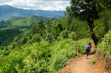 NEAR PHONGSALY, LAOS - AUGUST, 2017 : Hiker walking in a mountains  located in North of Laos.