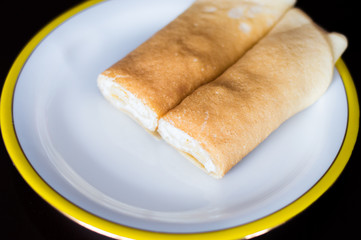 Rolled nalesnik stuffed with cheese. Nalesnik is Polish pancake.