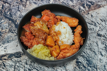 Rice with deep fried chicken,sliced picklesl topped Japanese yellow curry .