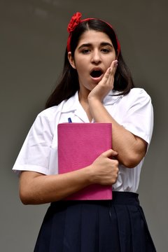 Surprised Catholic Girl Student Wearing Uniform With Notebook