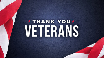 Thank You Veterans Text with American Flags Over Dark Blue Paper Background Texture