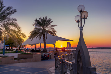 Abu Dhabi, UAE - Jan 12, 2018. Corniche boulevard beach park along the coastline in Abu Dhabi at...