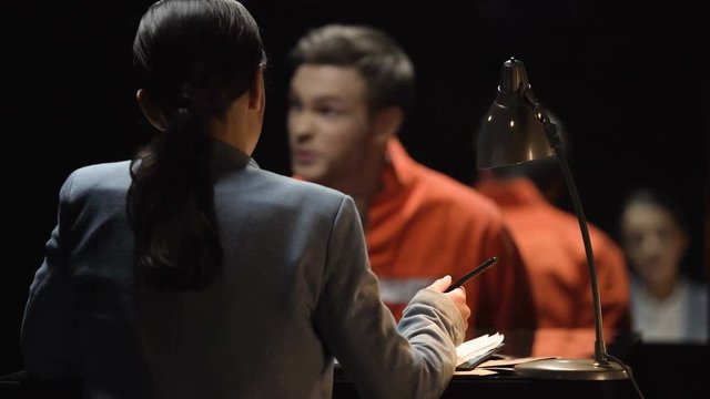 Criminal man and lady prosecutor discussing defense line and imprisonment terms