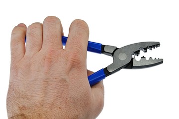 Electrical Crimping stripping pliers with blue rubber handle held in left hand of adult male person, opened jaws, white background.