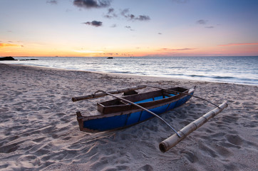 boat by the beach during sunset.