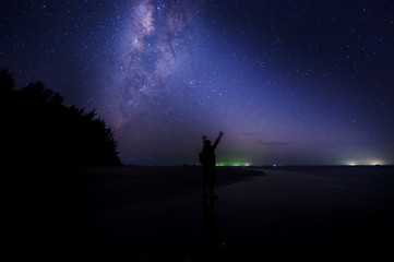 Fototapeta premium milkyway galaxy rise above lone tree at Kudat, Sabah Malaysia. Image contain soft focus, blur and noise due to long expose and high iso. Long expose and high iso setting need in night photo. 