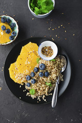 Quinoa orange blueberry bowl for breakfast with flax seeds. The concept of eating. Top View