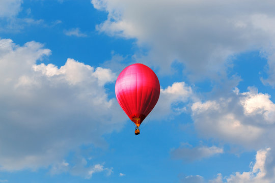 Red Hot Air Balloons Flying In Blue Sky With Clouds