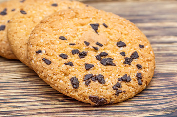 Cookies with chocolate on wooden table.