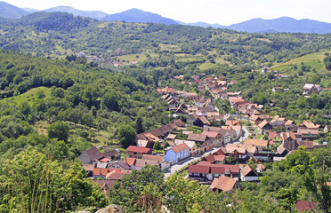 Fototapeta na wymiar View of small village Cisnadioara from the hill