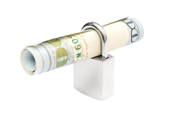 Rolled up dollar bill with padlock isolated on white background. Business concept.
