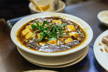 Diced tofu in minced pork and and mushroom gravy at the restaurant in Hanoi. Vietnam.