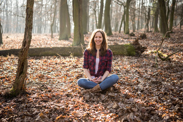 Woman sitting in forest and feel the nature