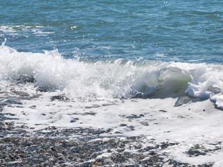 Wave splashs on pebble beach