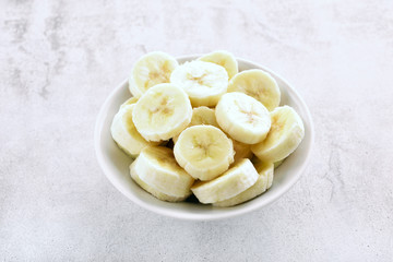 Sliced peeled banana in bowl.