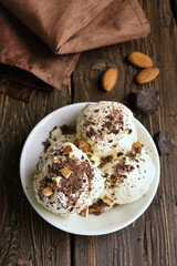Fototapeta na wymiar Scoops of vanilla chocolate ice cream with nuts
