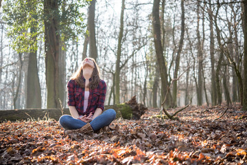 Woman sitting in forest and feel the nature