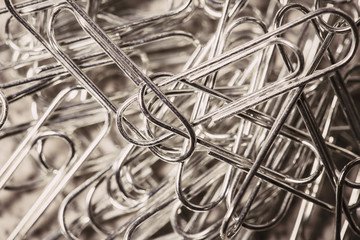Many paper clips on a brown vintage effect background