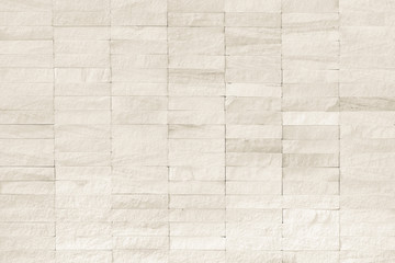 Fototapeta premium Rock stone tile wall texture rough patterned background in white cream color