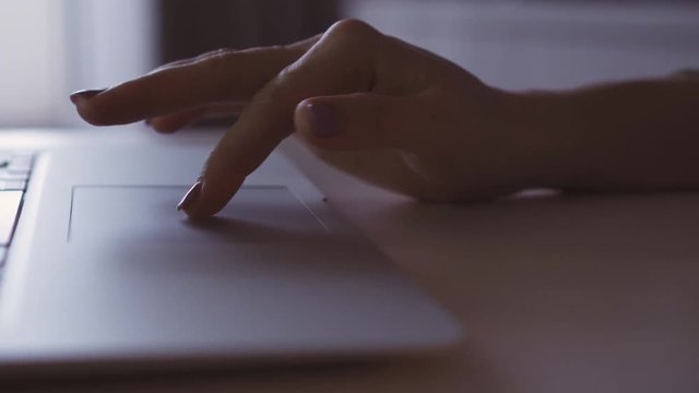 Person using touchpad on laptop