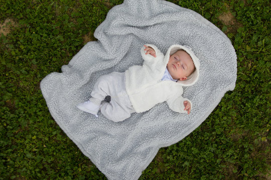 Cute baby lying on the pillow in the park