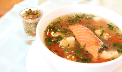 appetizing salmon fish soup with greens
