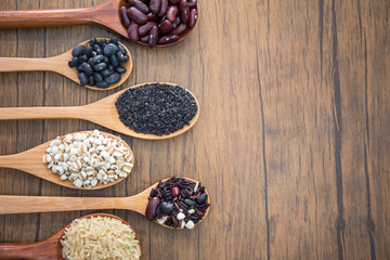 Obraz na płótnie Canvas Cereal grains , seeds, beans on wooden background.