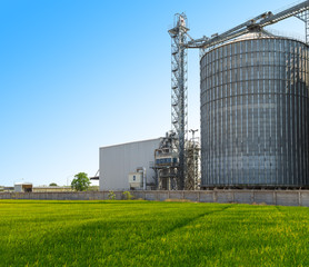 Agricultural Silos - Building Exterior, Storage and drying of grains, wheat, corn, soy, sunflower against the blue sky.