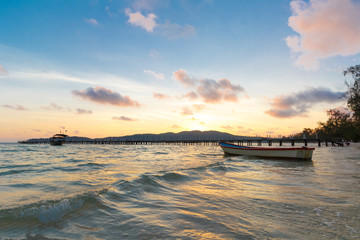 Sunrise with boat, Koh Rong Samloem, Saracen Bay, tropical paradise island with white beach and pier