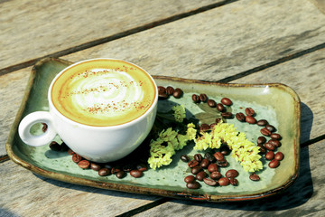Hot coffee cappuccino in white cup decorated on wooden background.